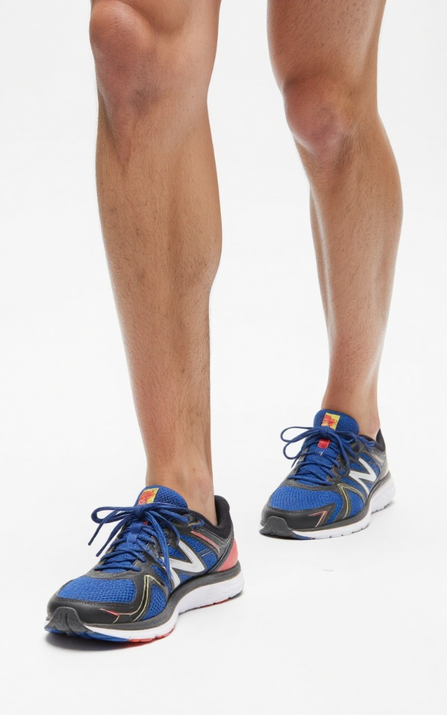 A male model wearing Running shoes, against a white background, with a close   up of the feet
